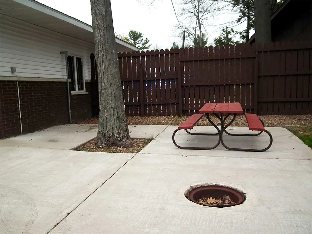 Camping room patio with a picnic table and fire pit