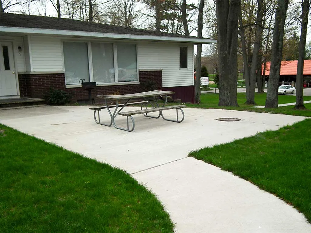 Duplex patio with a picnic table and walkway