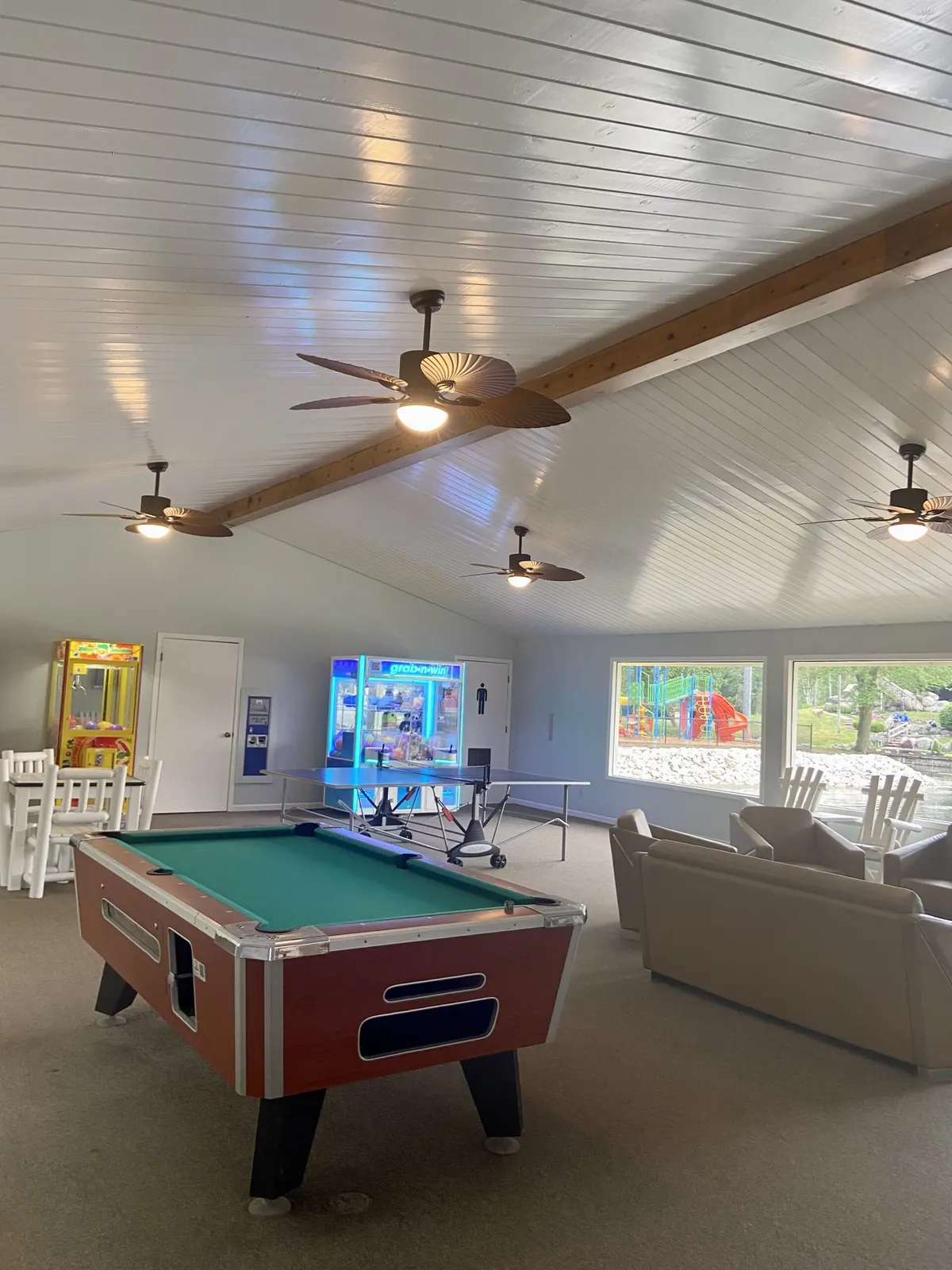 Recreation room with a pool table and arcade games