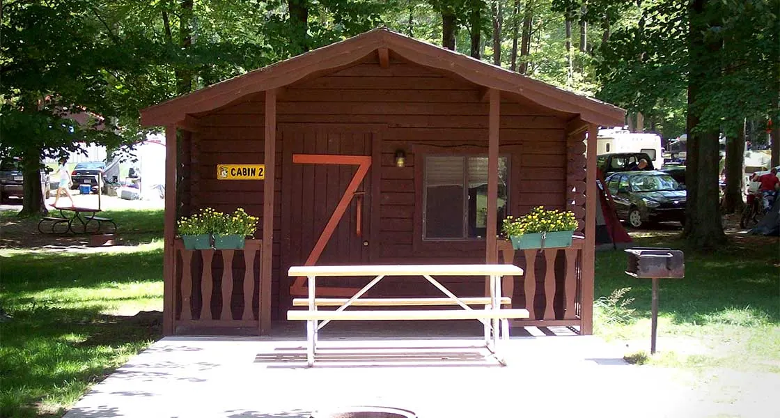 Wooden rustic cabin with a picnic table out front